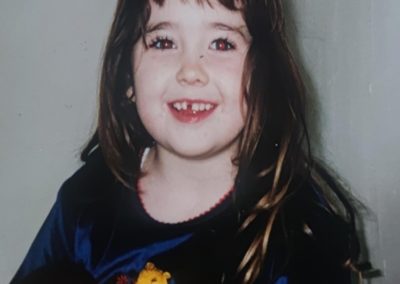 Laura as a child - A young white girl with brown hair.