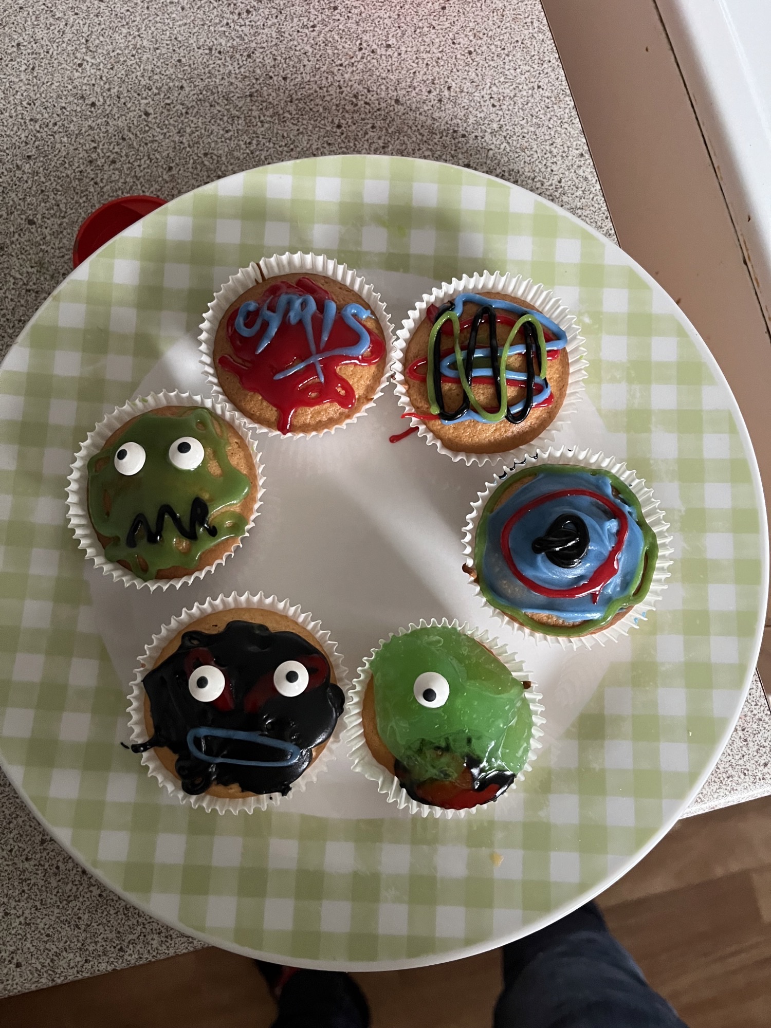 A selection of Halloween themed cupcakes in a variety of colours and designs.