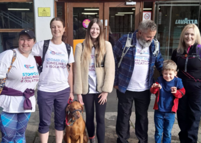 A group photo of six people and a dog outside of the Edinburgh Ratho Climbing Centre