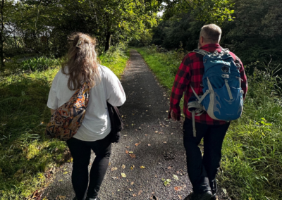 A man and a woman are walking down a path