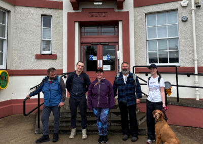 A group photo of five people and a dog outside of Carr Gomm's head office SPACE at the end of the Canal Challenge