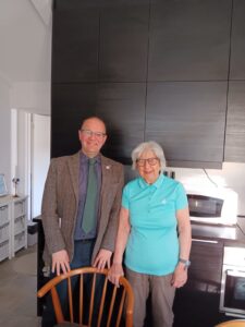 Sweden Peer Learning Visit: A man and a women smile at the camera in a modern kitchen.