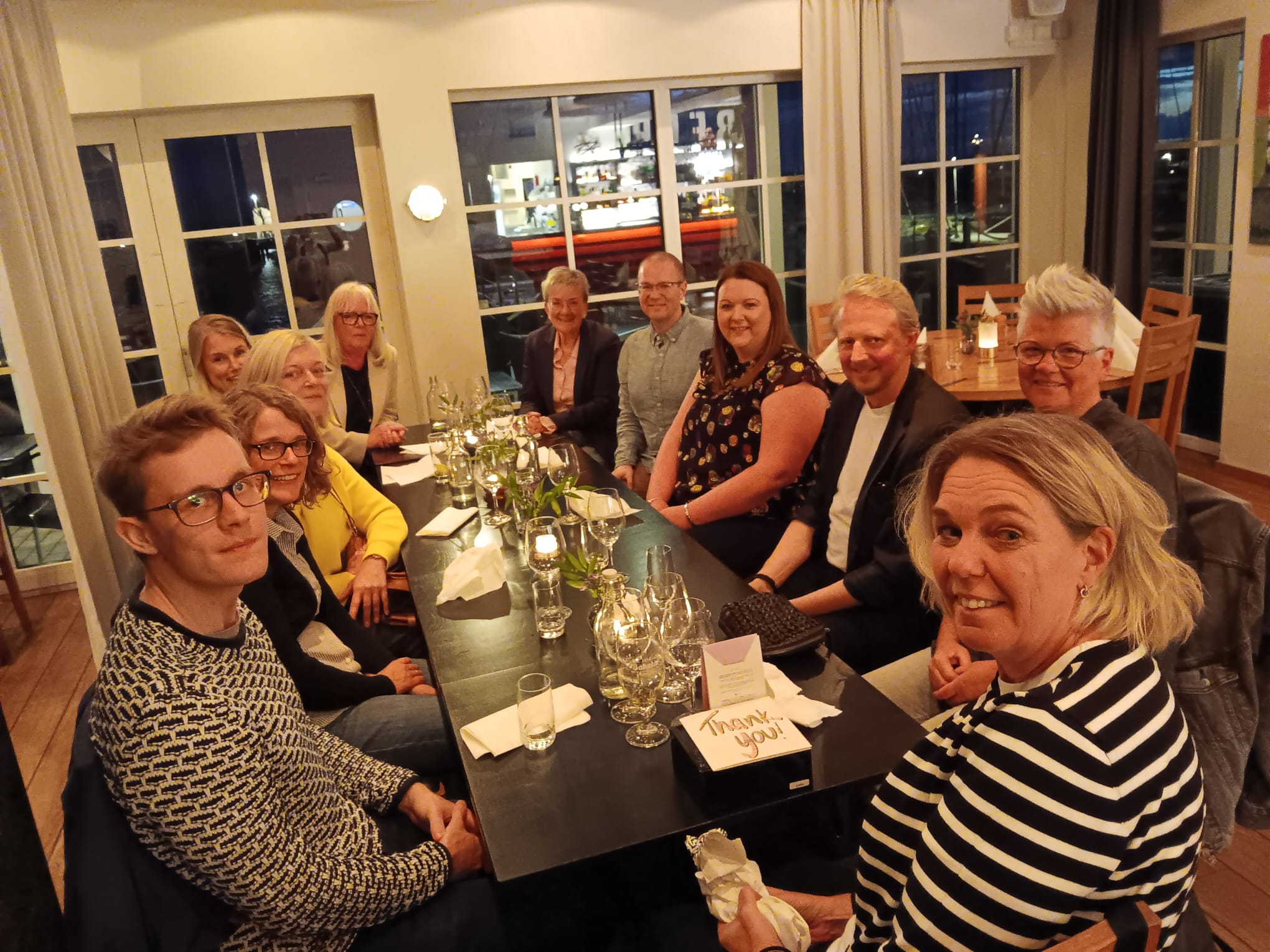 Sweden Peer Learning Visit: A couple of people sit in a restaurant, smiling at the camera.