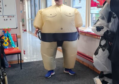 A plan is dressed in an inflatable sumo wrestler suit.