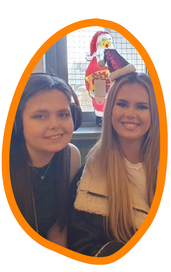 Two women smile at the camera.