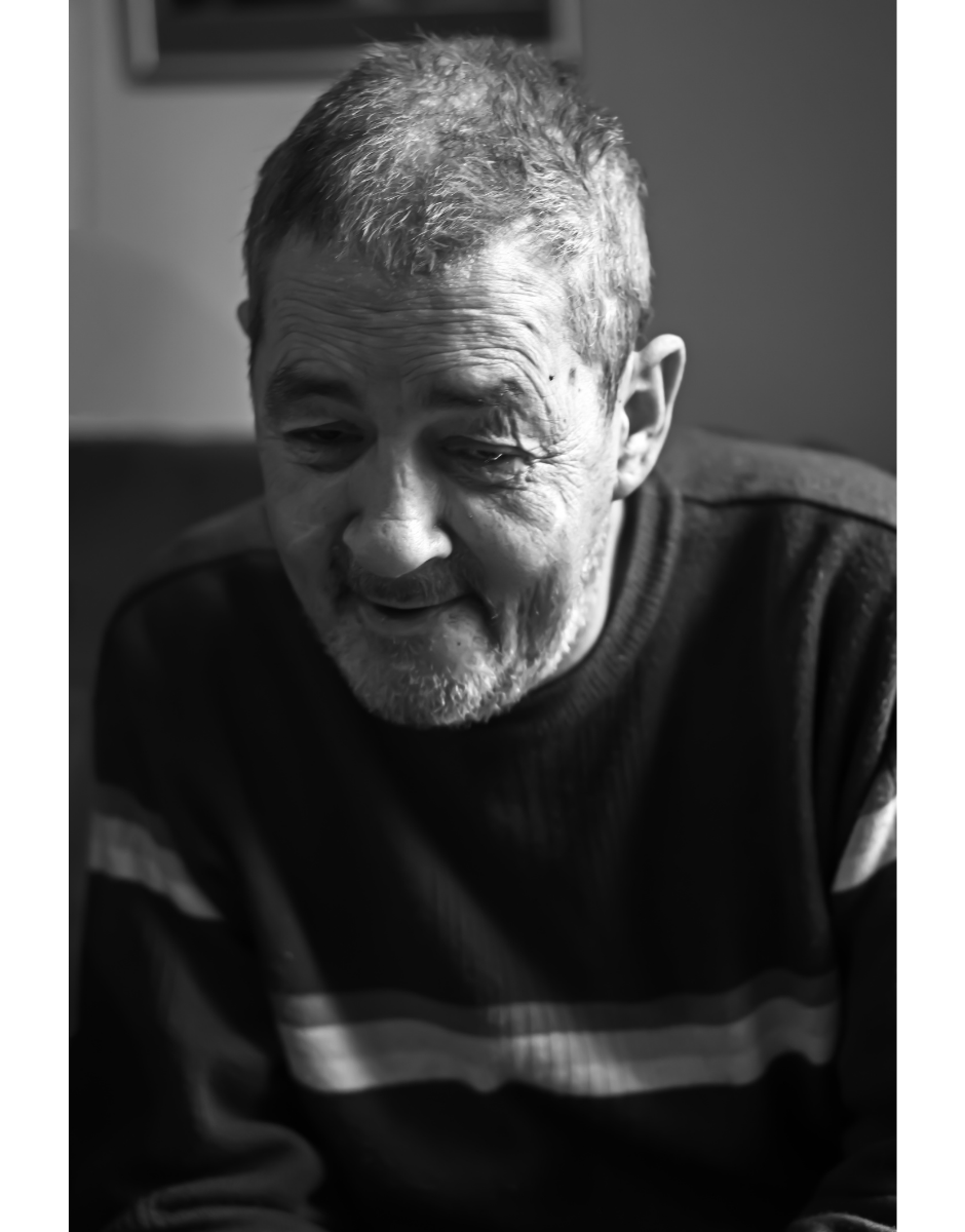 a black and white photo of a man sitting in a chair. | Carr Gomm