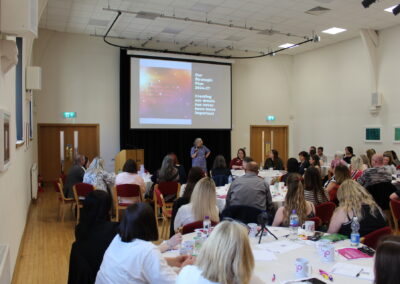 A group of people are listening to a presentation