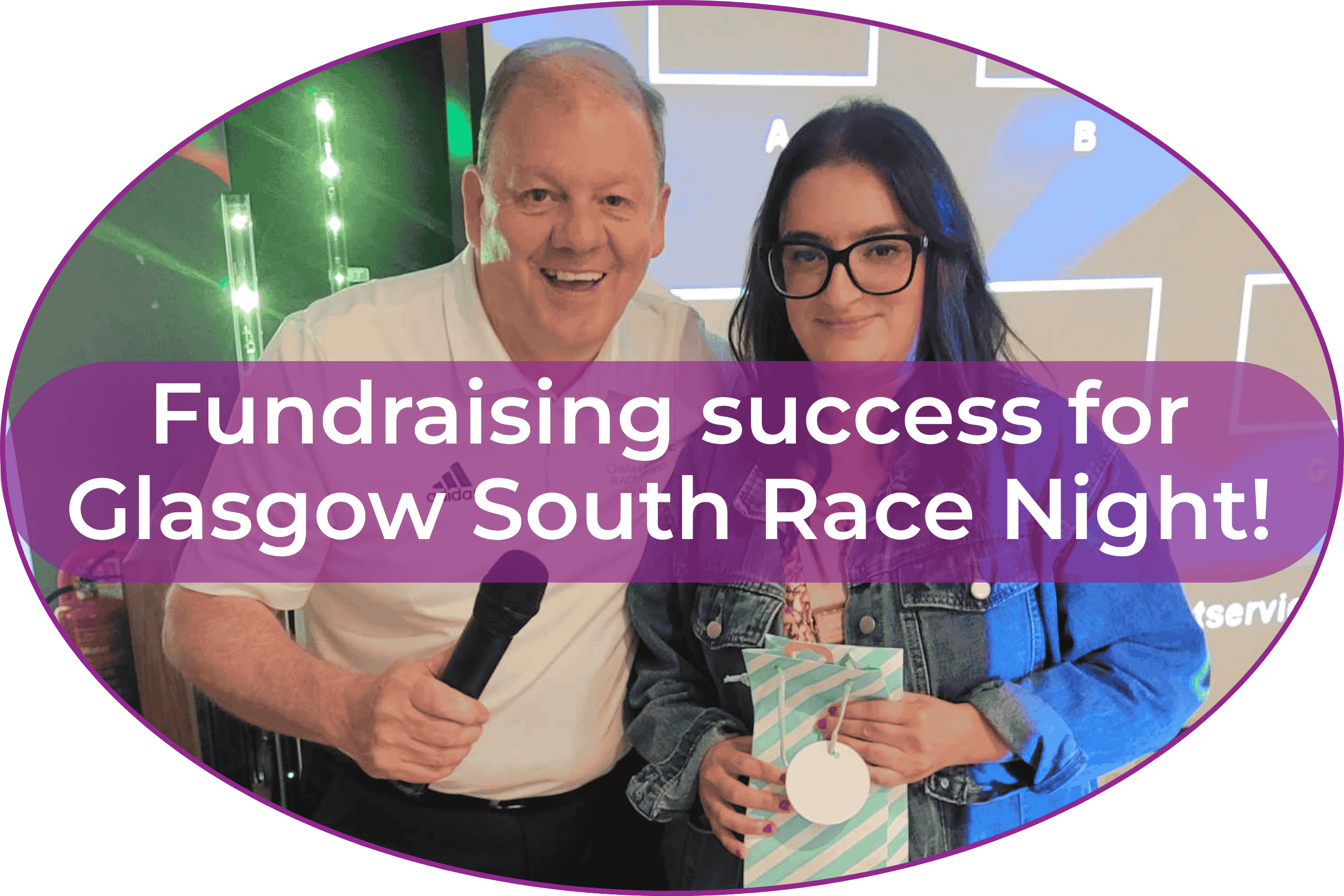 Blog Footer (3) Two people smile at the camera. One is holding a microphone and one is holding a gift bag.