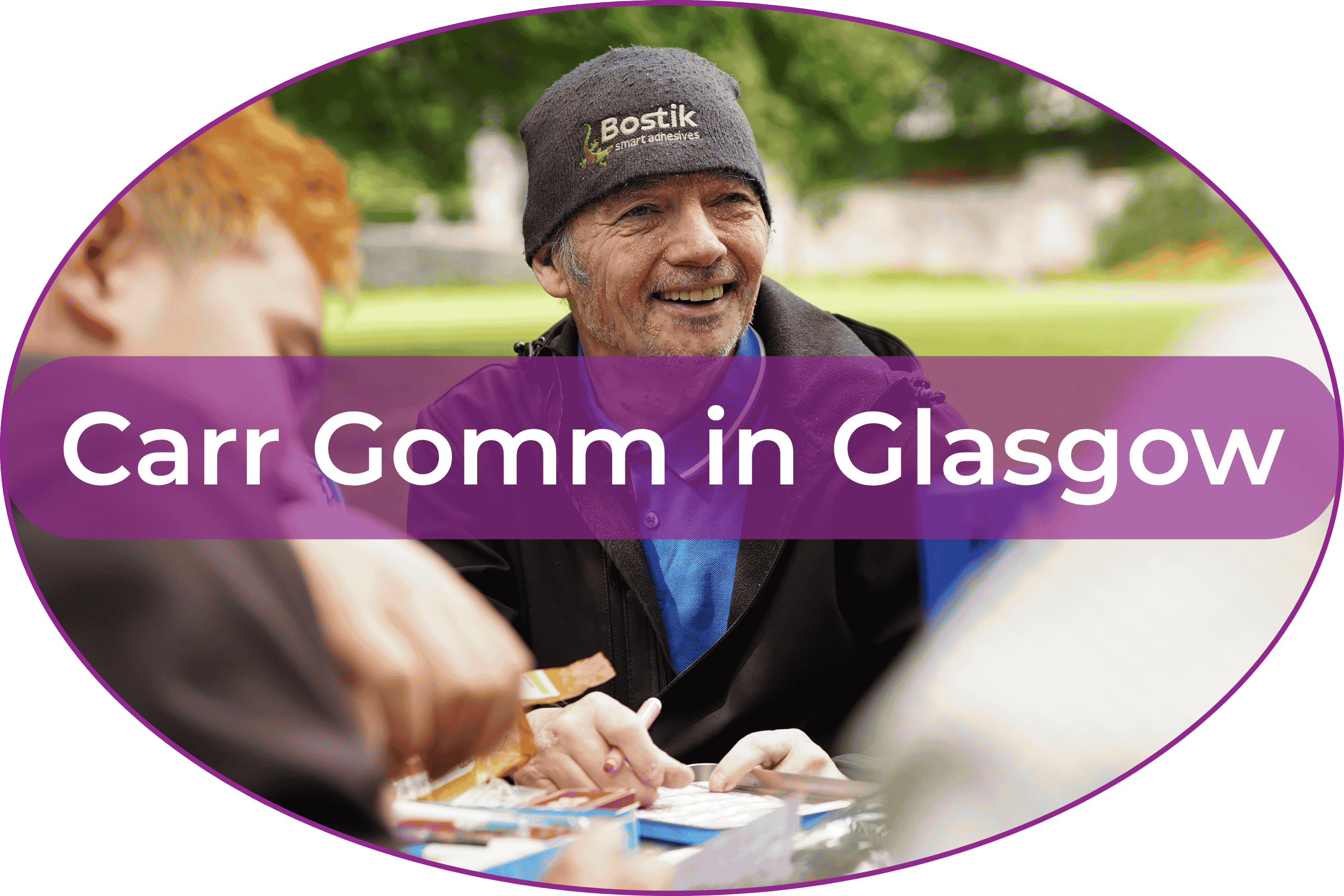 Blog Footer (4) A man is at a picnic table, smiling. The back of two other people is visible