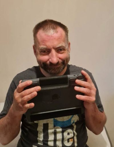 Person holding a tablet in front of their face