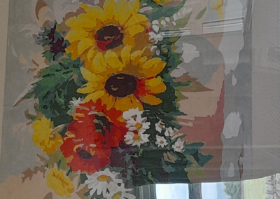 A painting of sunflowers in a frame.