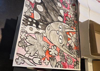 A black and red drawing of a cat.