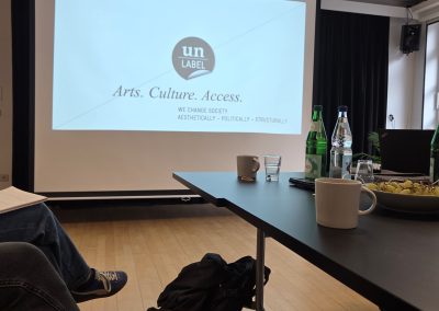 A projection screen with information about Un-Label.