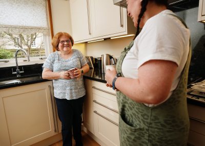 Two women chatting in a kitchen