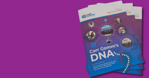 A stack of Carr Gomm magazines on a purple background