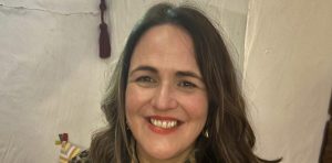 Woman with brown hair smiling at camera.| Carr Gomm