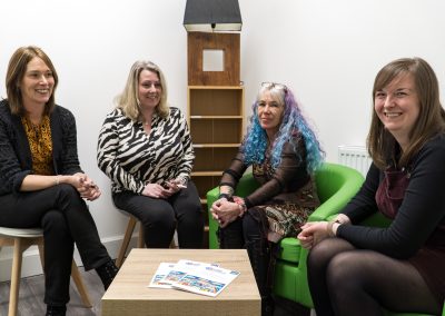 A group of women sitting together in a room