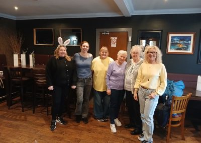 A group of people pose for a picture in a restaurant.